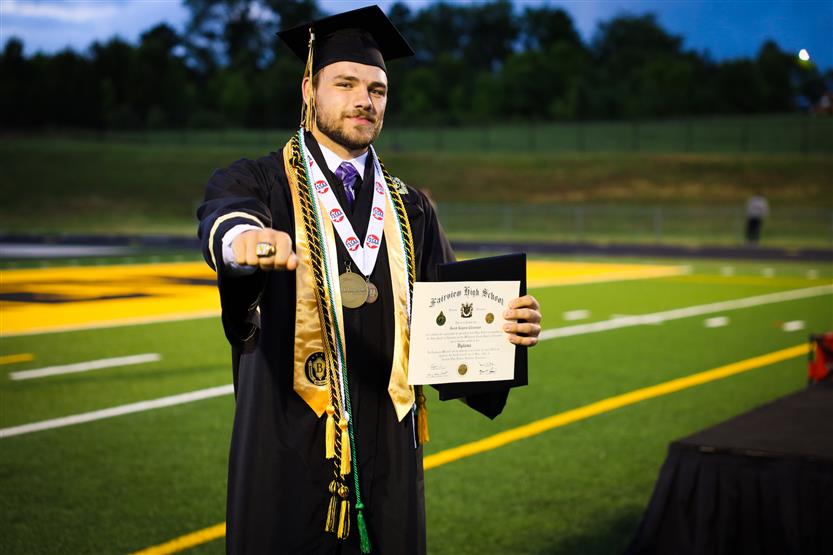 Students graduate on a football field